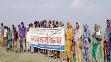 ধর্মপাশায় গুচ্ছগ্রাম অন্যত্র স্থানান্তরের দাবীতে মানববন্ধন